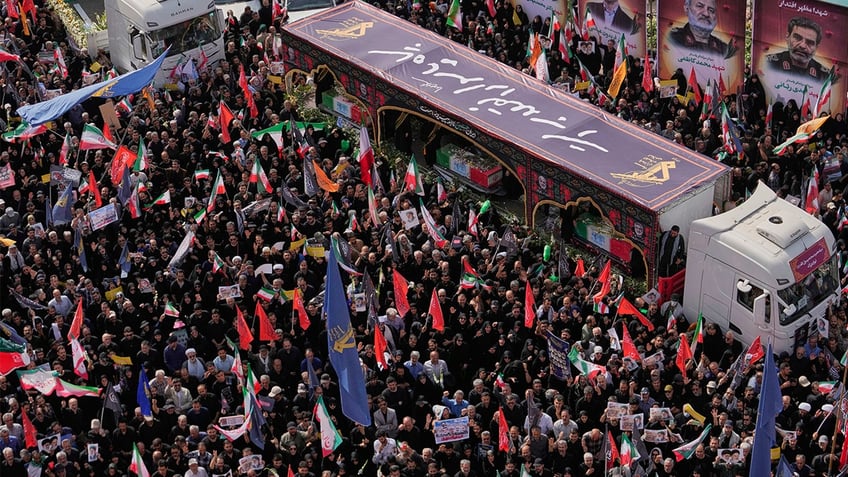 Iran holds funeral for scientists, commanders killed in war