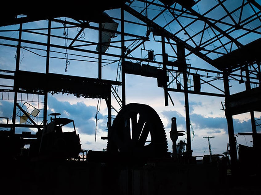 A giant rusty wheel which once squeezed the juice from sugar cane in the Hershey sugar mil