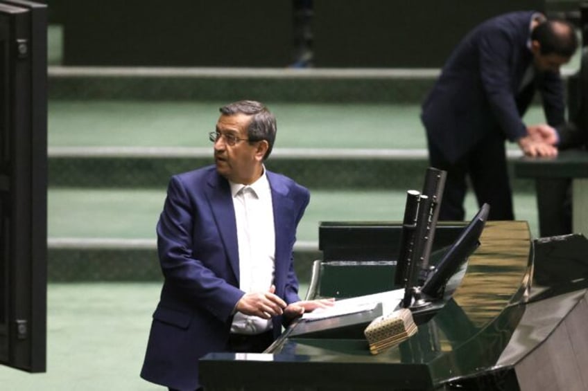 Iranian Finance Minister Abdolnaser Hemmati delivers a speech in parliament during impeach