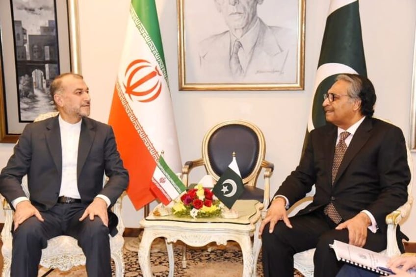 Pakistan Foreign Minister Jalil Abbas Jilani (right) with his Iranian counterpart Hossein Amir-Abdollahian in a Pakistan government handout photo