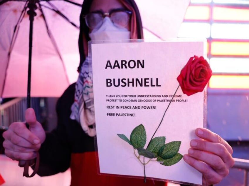 NEW YORK, NEW YORK - FEBRUARY 27: A person holds a sign at a vigil for U.S. Airman Aaron B