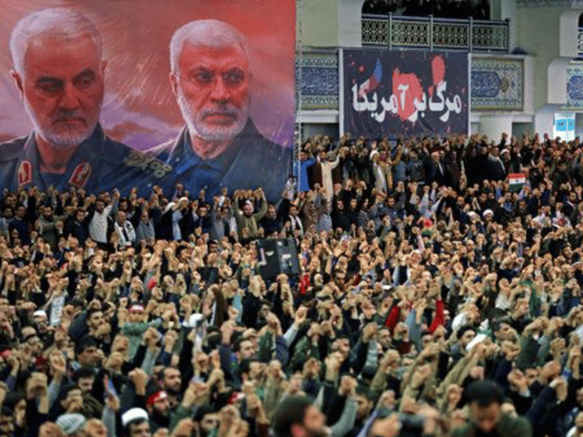 In this picture released by the official website of the office of the Iranian supreme leader, worshippers chant slogans during Friday prayers ceremony, as a banner show Iranian Revolutionary Guard Gen. Qassem Soleimani, left, and Iraqi Shiite senior militia commander Abu Mahdi al-Muhandis, who were killed in Iraq in a U.S. drone attack on Jan. 3, and a banner which reads in Persian: "Death To America, "at Imam Khomeini Grand Mosque in Tehran, Iran, Friday, Jan. 17, 2020. Iran's supreme leader said in his sermons President Donald Trump is a "clown" who only pretends to support the Iranian people but will "push a poisonous dagger" into their backs, as he struck a defiant tone in his first Friday sermon in Tehran in eight years. (Office of the Iranian Supreme Leader via AP)