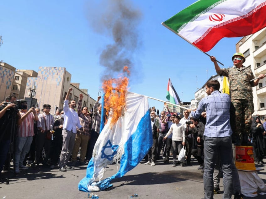 Iranians burn an Israeli flag during the annual Quds (Jerusalem) Day commemorations and th