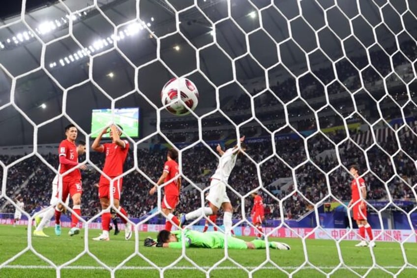 Iran forward Mehdi Ghayedi celebrates after scoring