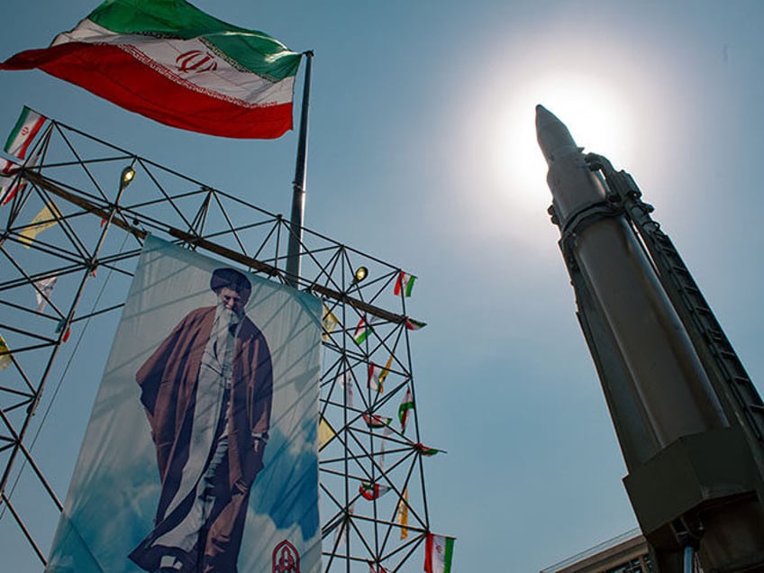 A big banner depicting Iran's Supreme Leader Ayatollah Ali Khamenei is placed next to a ba