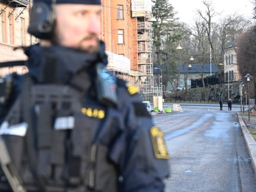 Police officers are seen outside the Israeli embassy in Stockholm, January 31, 2024. A han