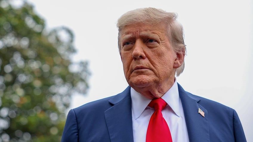 President Donald Trump stops and talks to the media before he boards Marine One following Israel launching strikes on Iran in June. 