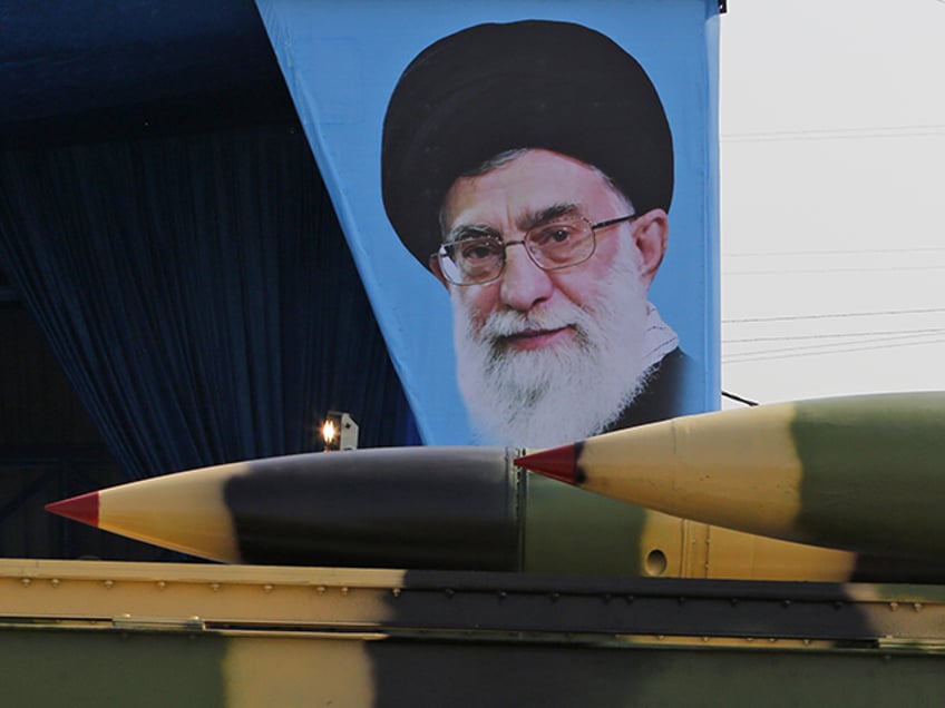 An Iranian military truck carries surface-to-air missiles past a portrait of Iran's Supreme Leader Ayatollah Ali Khamenei during a parade on the occasion of the country's annual army day on April 18, 2018, in Tehran. - President Hassan Rouhani said that Iran "does not intend any aggression" against its neighbours but will continue to produce all the weapons it needs for its defence. (Photo by ATTA KENARE / AFP) (Photo by ATTA KENARE/AFP via Getty Images)