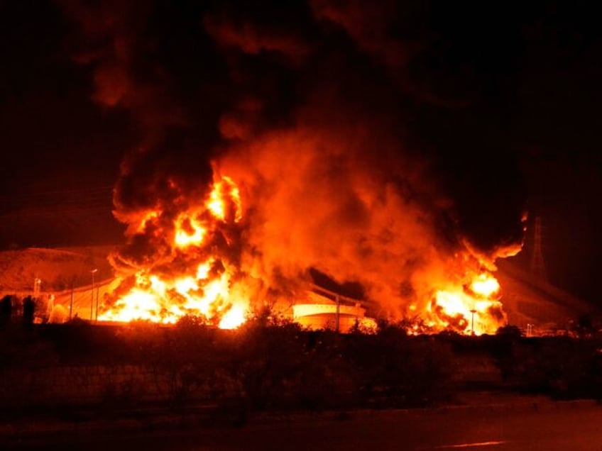 Flames rise from an oil storage facility after it appeared to have been hit by an Israeli