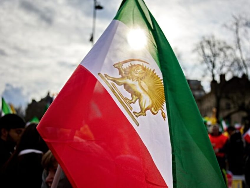 People take part in a demonstration organized by members of the Iranian opposition, includ