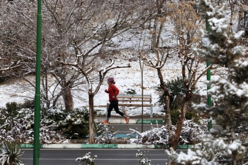 Not too cold for exercise: a woman in Tehran jogs amid the snow