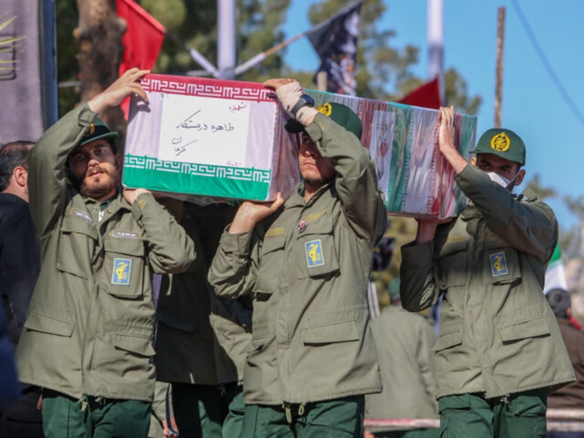 KERMAN, IRAN - JANUARY 5: Coffins carried by Revolutionary guard soldiers during the funeral ceremony for victims of twin explosions, on January 05, 2024, in Kerman, Iran. On Wednesday, 84 people were killed here when bombs exploded during a memorial procession to mark the fourth anniversary of Qasem Soleimani's assassination …