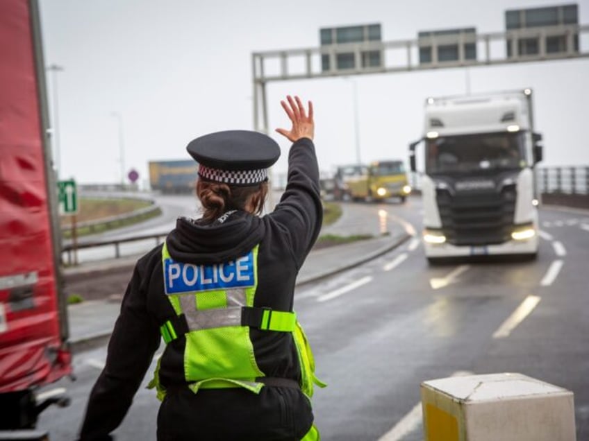 Police manage freight lorry drivers as the French border closures due to a new strain of C
