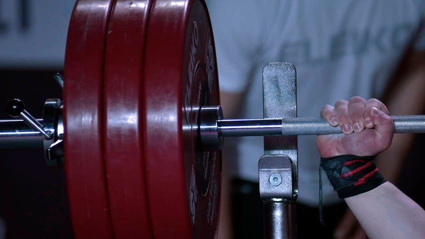 iranian weightlifter banned for life after shaking hands with israeli opponent