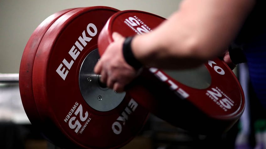 iranian weightlifter banned for life after shaking hands with israeli opponent