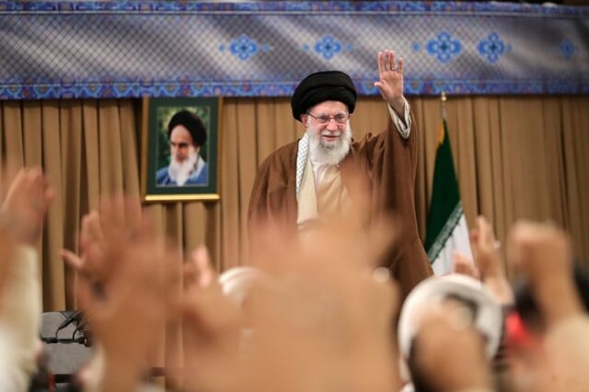 Iran's supreme leader Ayatollah Ali Khamenei greeting the crowd during a meeting with Basi