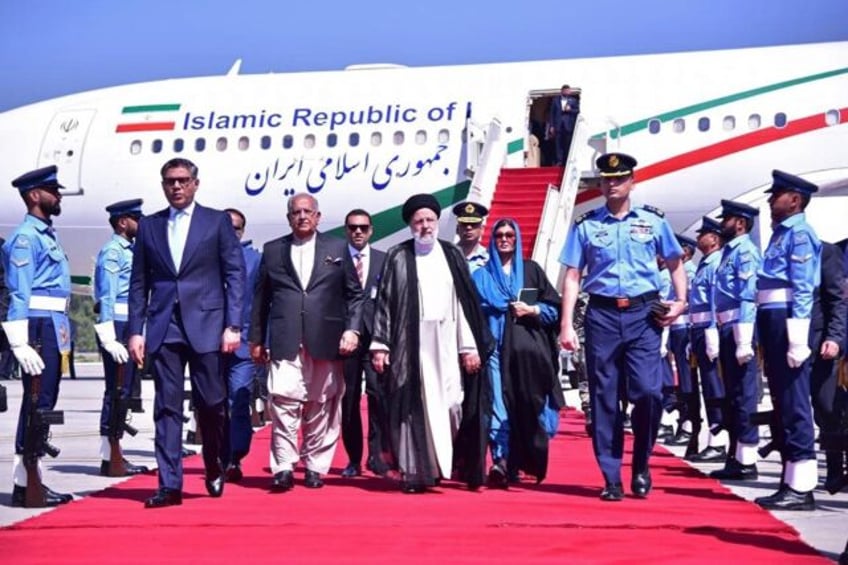Iranian President Ebrahim Raisi (C) arrives in Islamabad for talks with Pakistani leaders