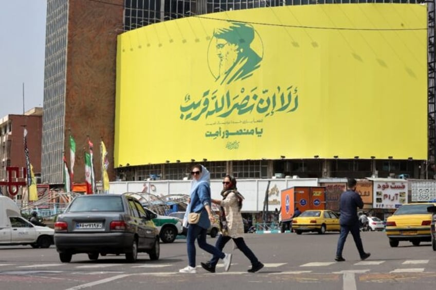 A large banner showing Hezbollah leader Hassan Nasrallah, on the facade of a building in c