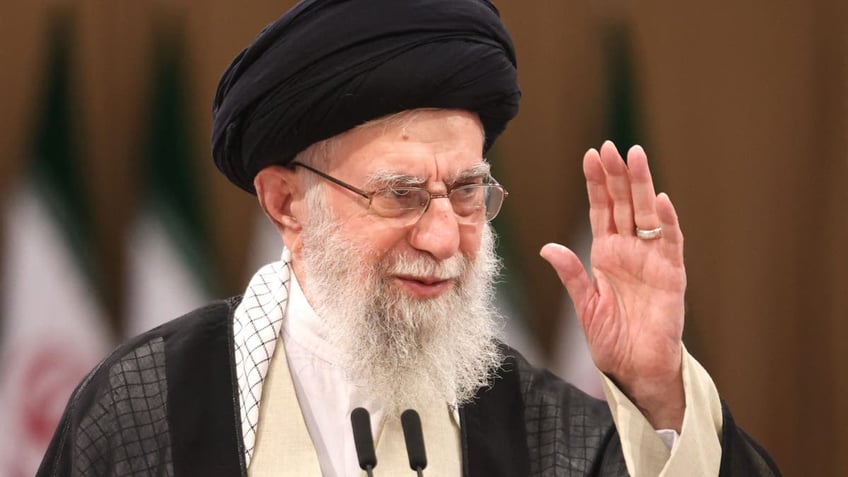 Ayatollah Khamenei waves in closeup shot