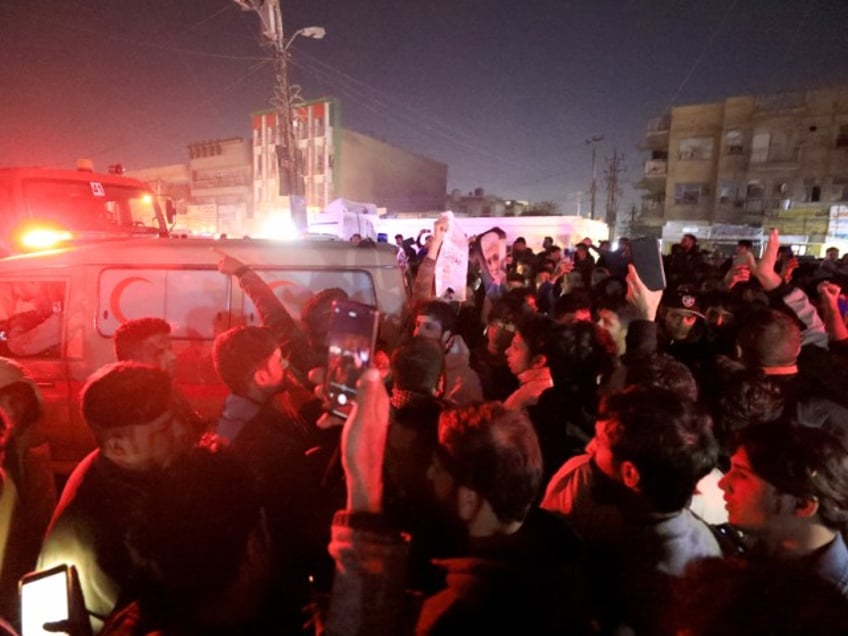 BAGHDAD, IRAQ - FEBRUARY 07: People inspect the vehicle targeted by airstrike in Baghdad, Iraq on February 07, 2024. At least 3 explosions heard across Iraqi capital Baghdad, local media report. (Photo by Murtadha Al-Sudani/Anadolu via Getty Images)