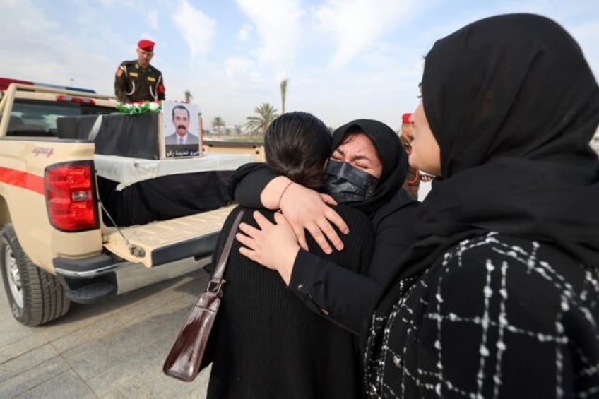 Relatives mourn during a solemn funeral ceremony for the 41 victims from the Yazidi minority who were executed by Islamic State group militants in 2014