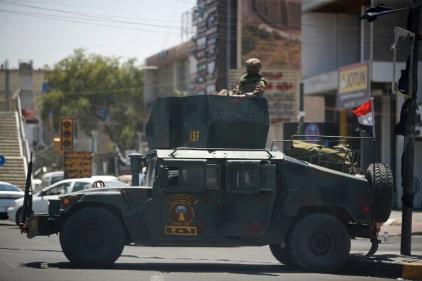 Iraqi security forces secure Baghdad's Palestine Street a day after dozens of men attacked