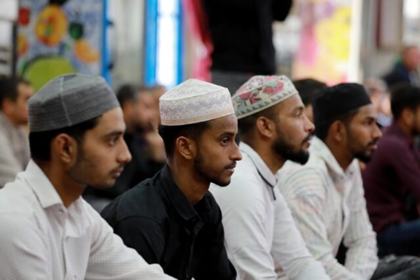 Foreign workers in Iraq attend prayers at Baghdad's Abdul Qader al-Jilani mosque. The coun