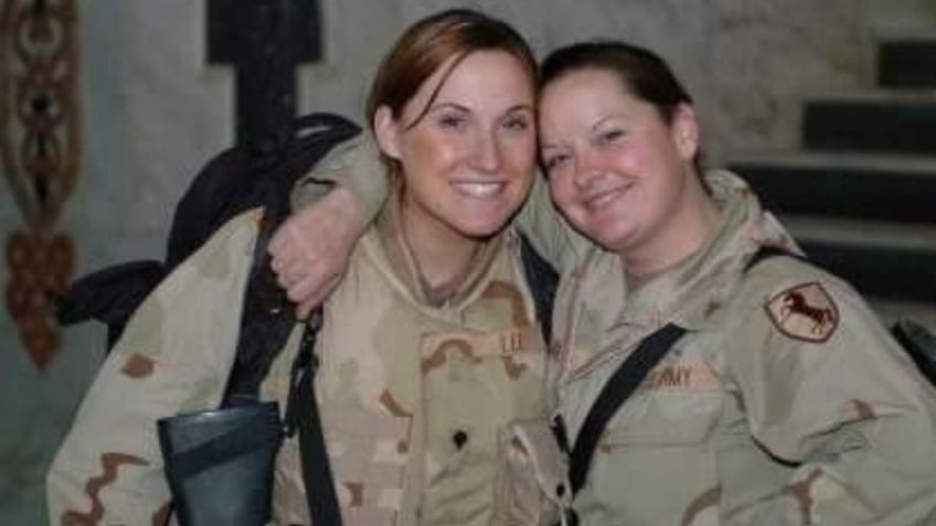 Jennifer Horn embracing a friend in the Army smiling.