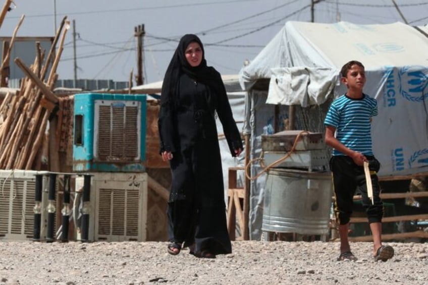 A woman and a boy in the camp near Hassan Shami for the internally displaced