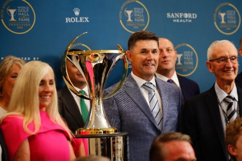 Ireland's Padraig Harrington, right-center, poses with family and friends prior to his ind