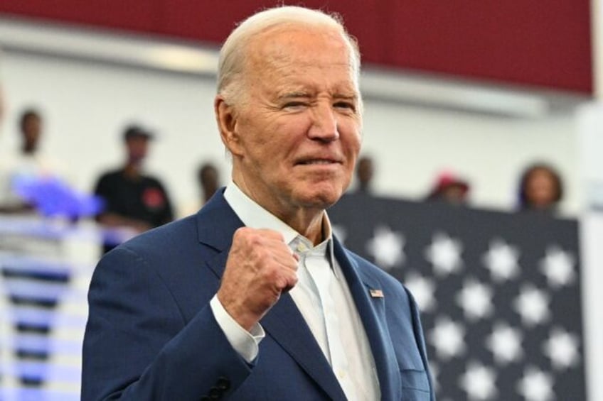 US President Joe Biden pumps his fist after speaking at a campaign event at Renaissance Hi