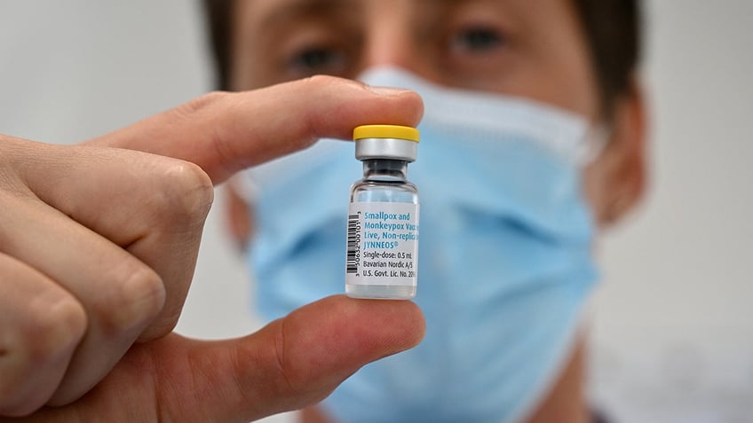 developer holds vial of mpox vaccine