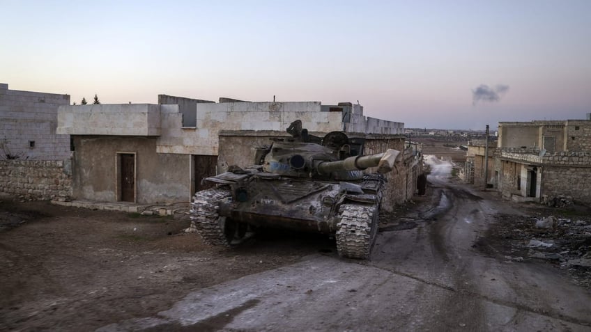 A destroyed Syrian army tank sits in the village of Anjara, western outskirts of Aleppo, Syria, Thursday Nov. 28, 2024. 