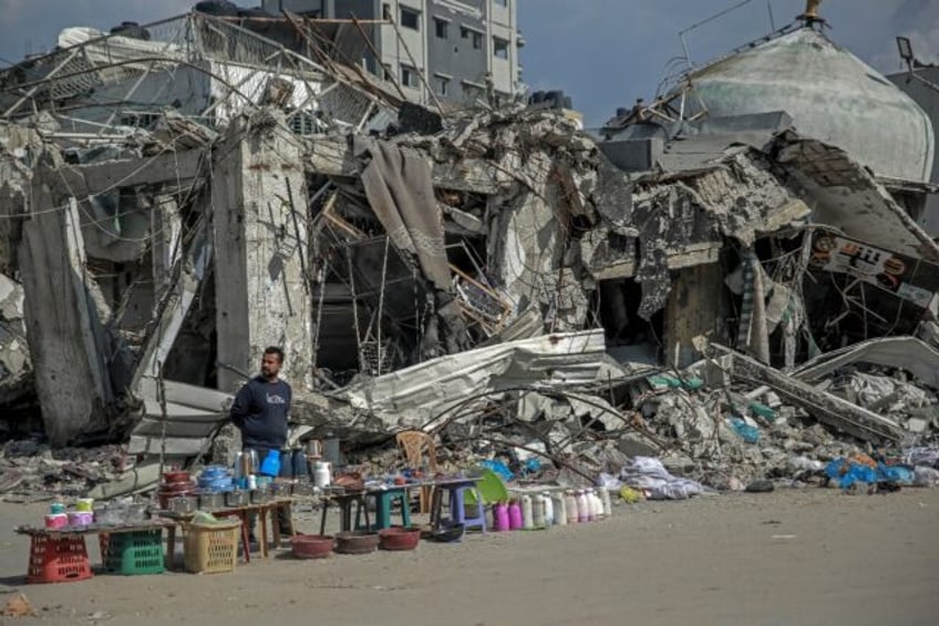 A vendor waits for customers along a street in Gaza City, in the north of the besieged Ham