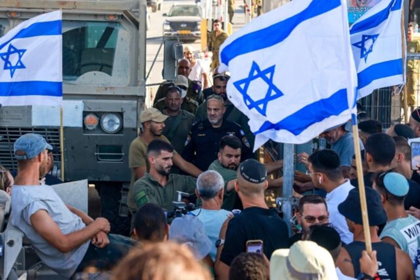 Israelis demonstrate next to the Sde Teiman military base near Beersheba, after nine soldi