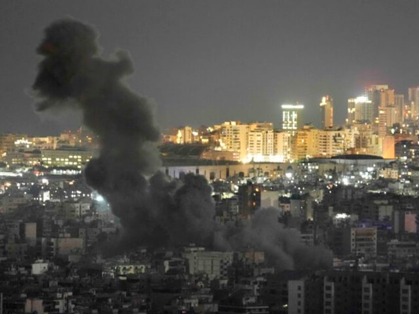 Smoke rise from an Israeli airstrike on Dahiyeh in the southern suburb of Beirut, as Beiru