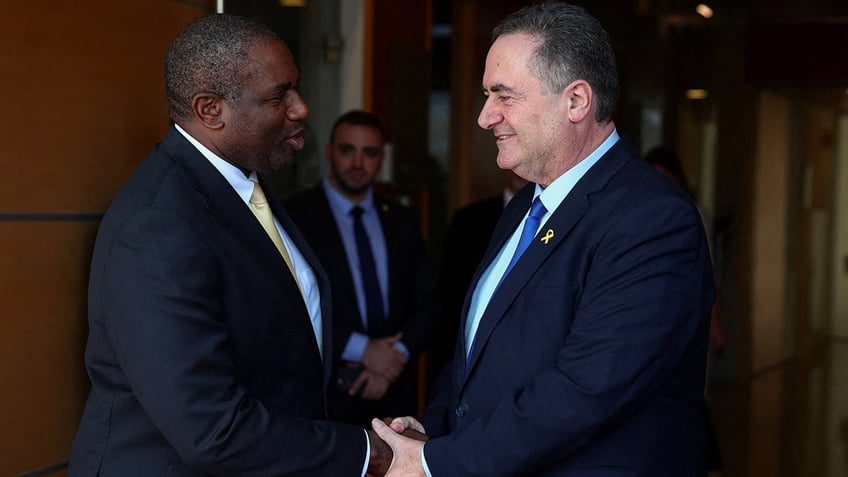 Britain's Foreign Secretary David Lammy shakes hands with Israeli Foreign Minister Israel Katz