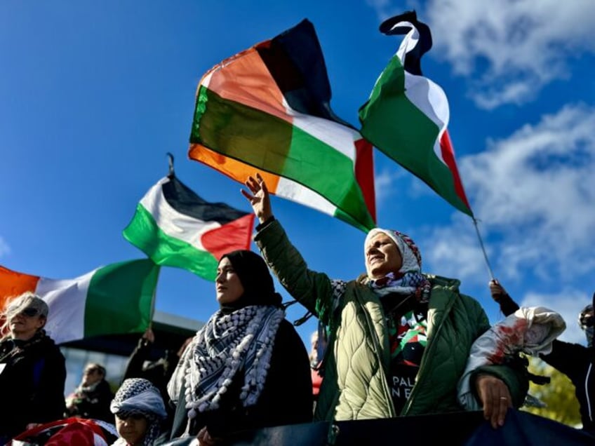 CLARE, IRELAND - OCTOBER 12: People holding banners and Palestinian flags march during a p