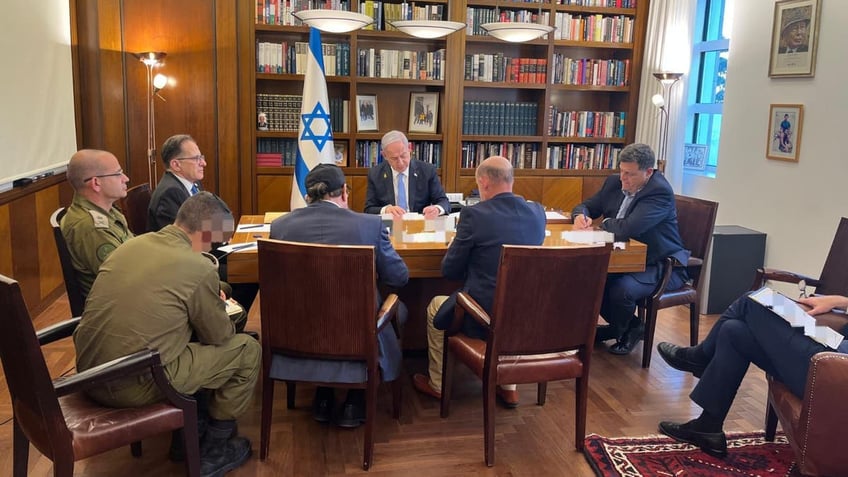 Israeli Prime Minister Benjamin Netanyahu takes notes during his telephone call with President Biden on Wednesday.