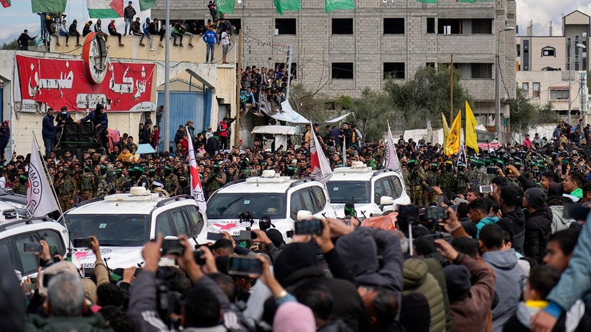 Palestinians watch parade of Israeli hostages through Gaza