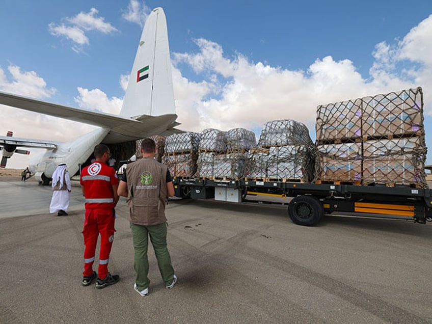 Staff members unload aid for the Palestinian Gaza Strip from an Emirates cargo plane on the tarmac of Egypt's el-Arish airport in the north Sinai Peninsula on October 19, 2023, amid the ongoing battles between Israel and the Palestinian group Hamas. Thousands of tonnes of aid bound for Gaza remained …