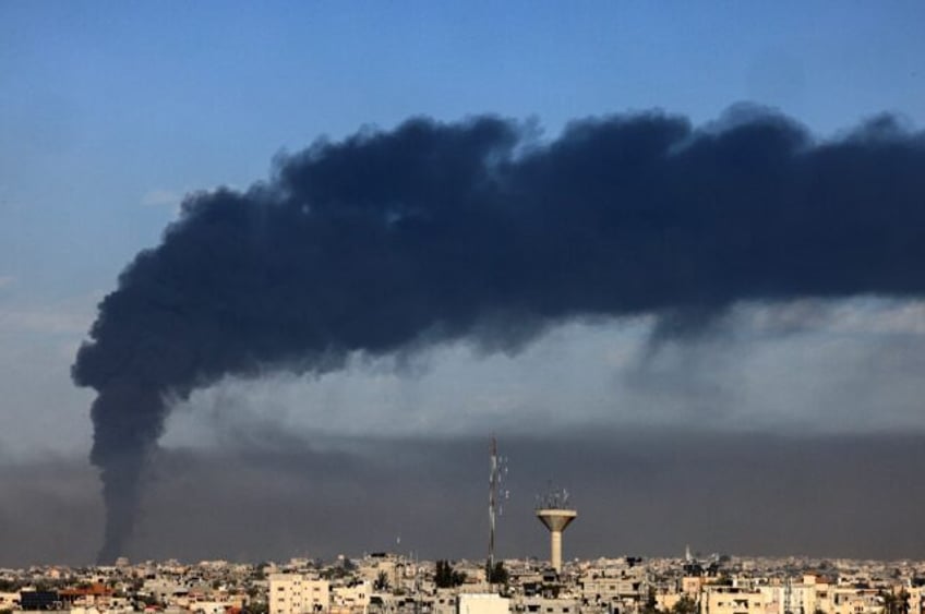 Black smoke billows over Khan Yunis in southern Gaza, the new epicentre of the war between Israel and Hamas