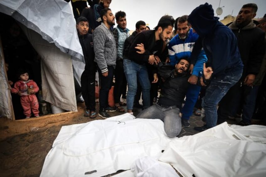 Mourners at a mass funeral in southern Gaza for Palestinians killed in an Israeli strike on Al-Maghazi refugee camp