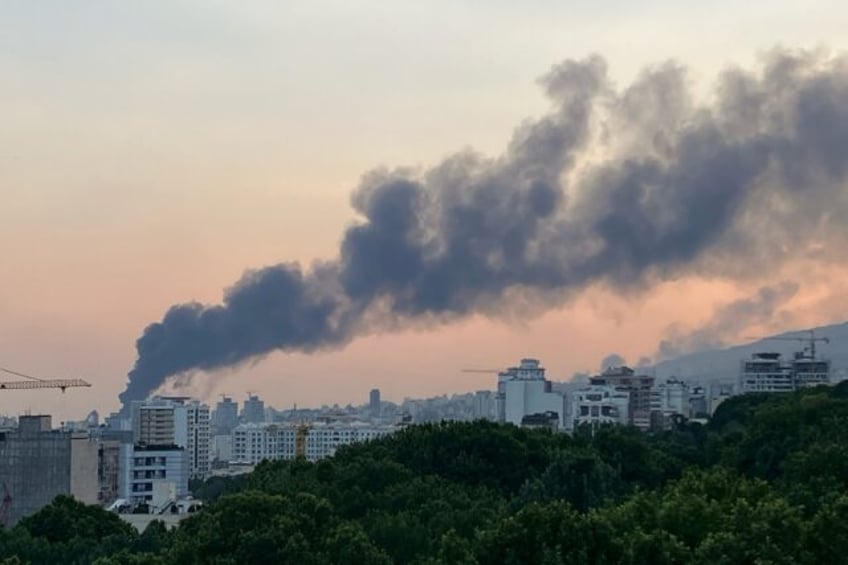 Smoke billows from an explosion at the Islamic Republic of Iran Broadcasting (IRIB) buildi