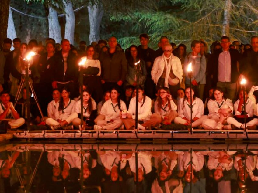 Israeli scouts light torches during a Memorial Day commemoration for fallen soldiers, or Y