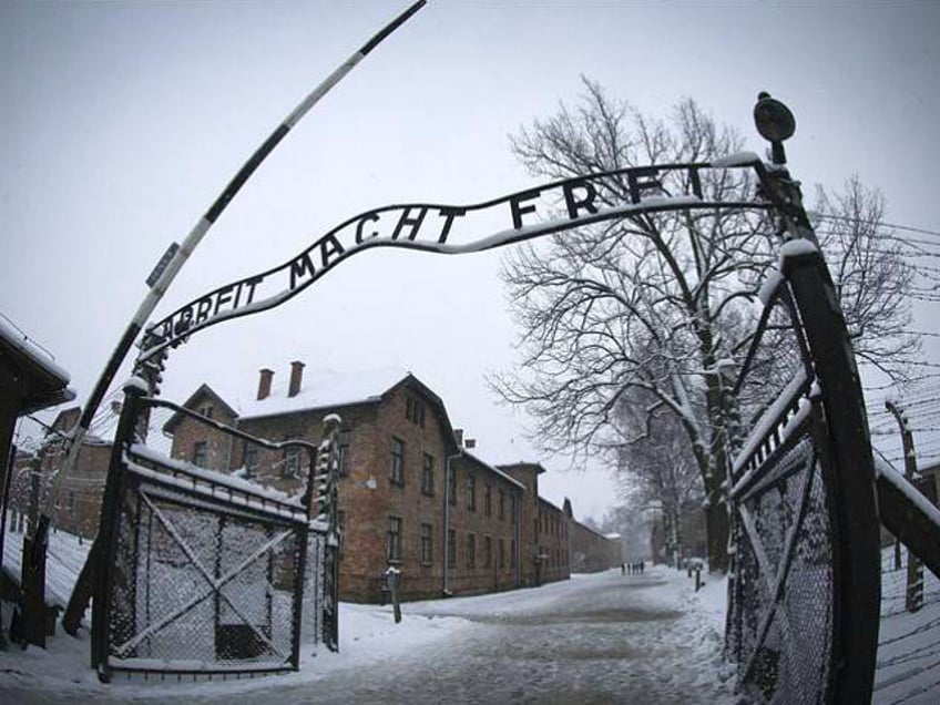 The entrance to the former Nazi concentration camp Auschwitz-Birkenau with the lettering '