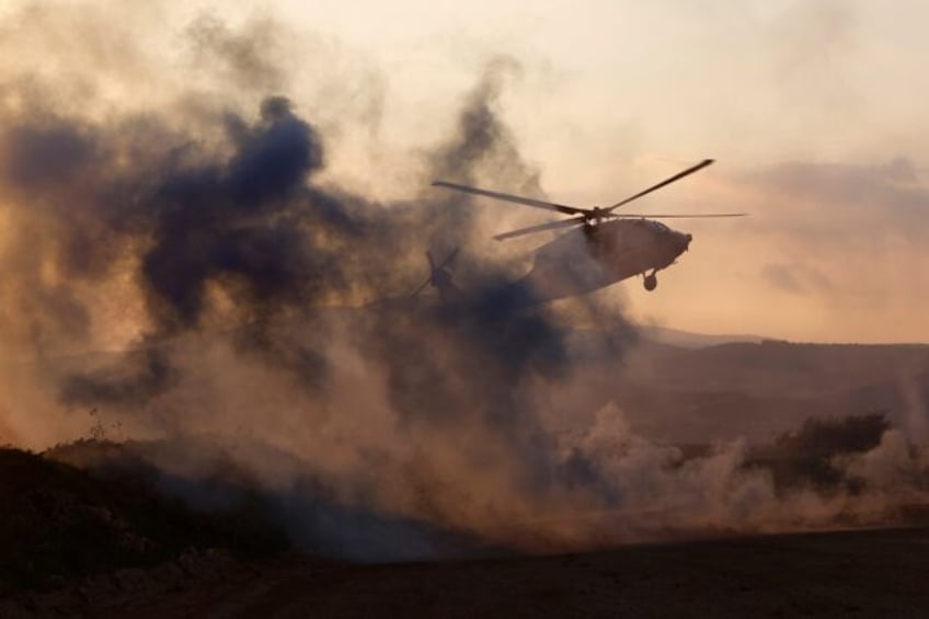 An Israeli helicopter takes off during a military exercise in Upper Galilee near the Leban