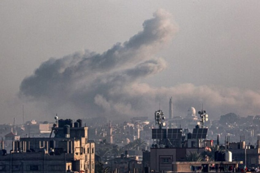 Smoke billows over Khan Yunis in the southern Gaza Strip during Israeli bombardment on January 16