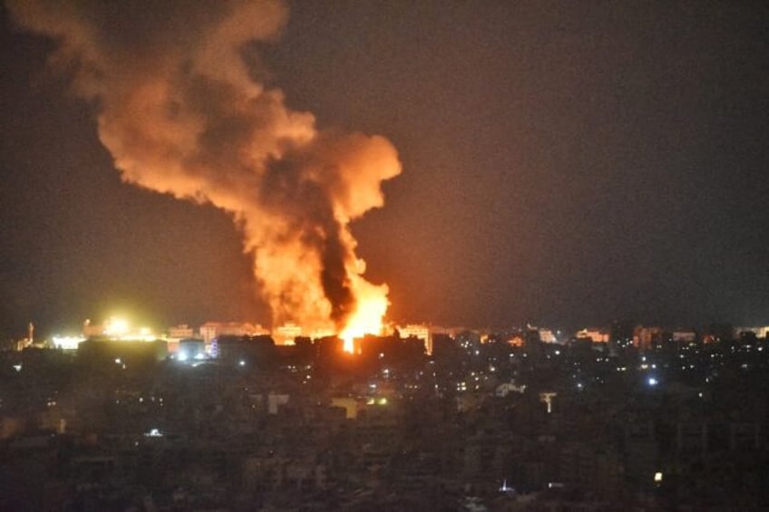 Fire and smoke rise over an area targeted by an Israeli air strike on Beirut's southern su