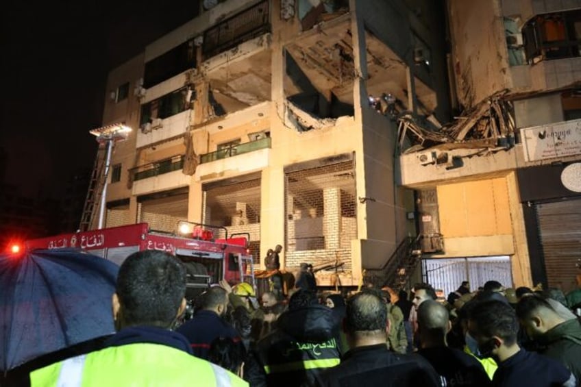 Lebanese emergency responders gather at the site of a strike attributed to Israel that killed a Hamas deputy